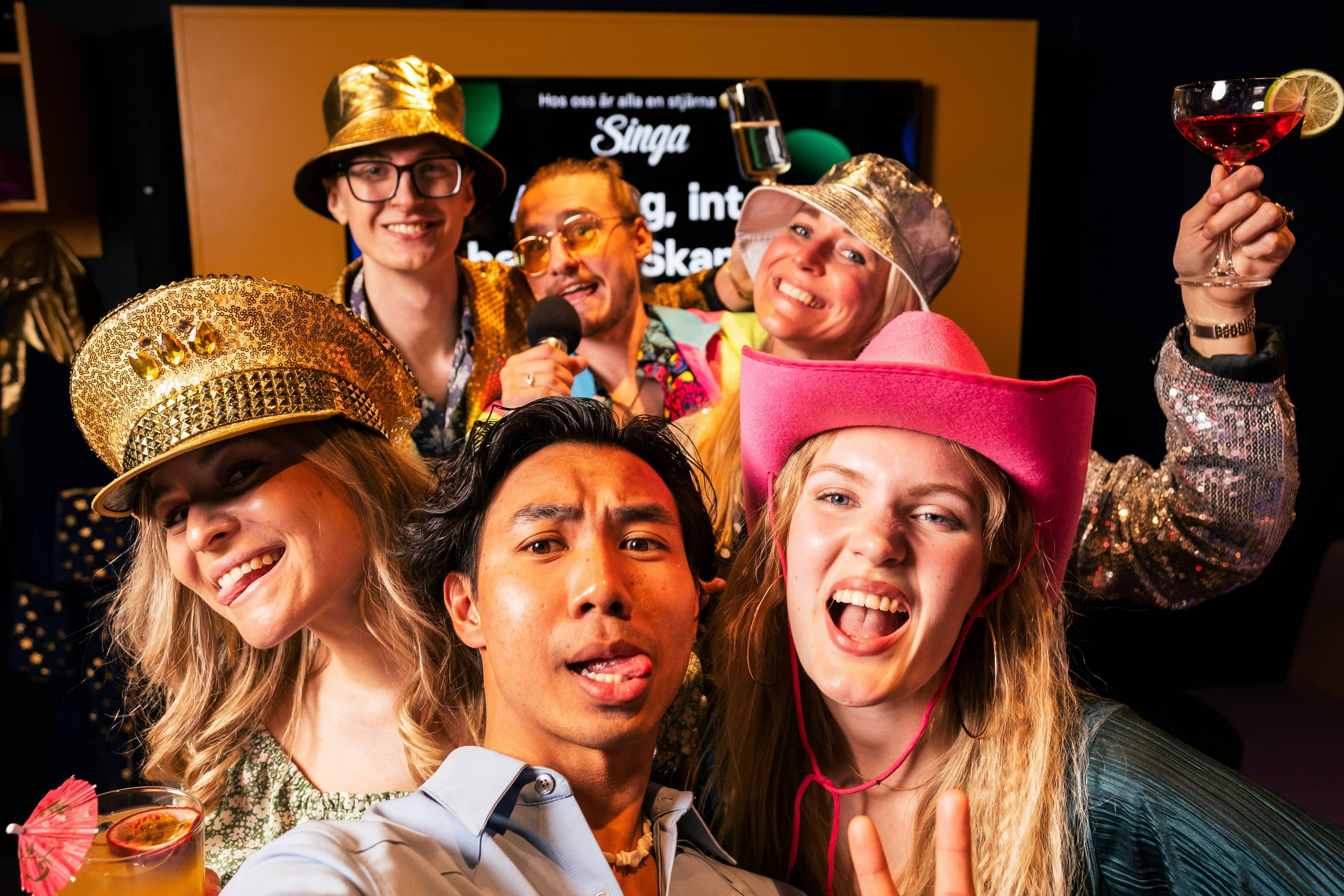 A group of colleagues in costumes posing together at an event