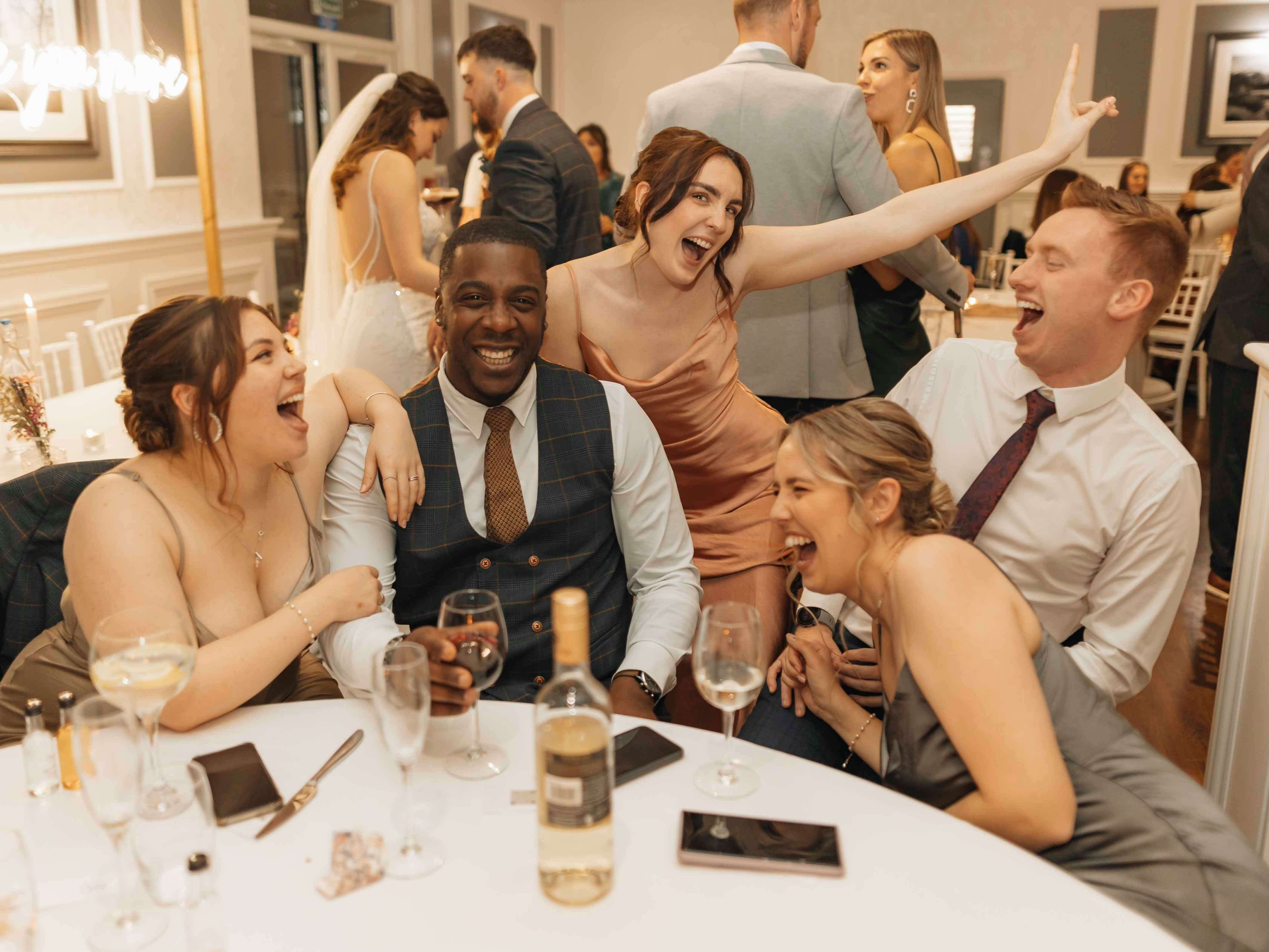 Guests gathered around a table at a wedding reception