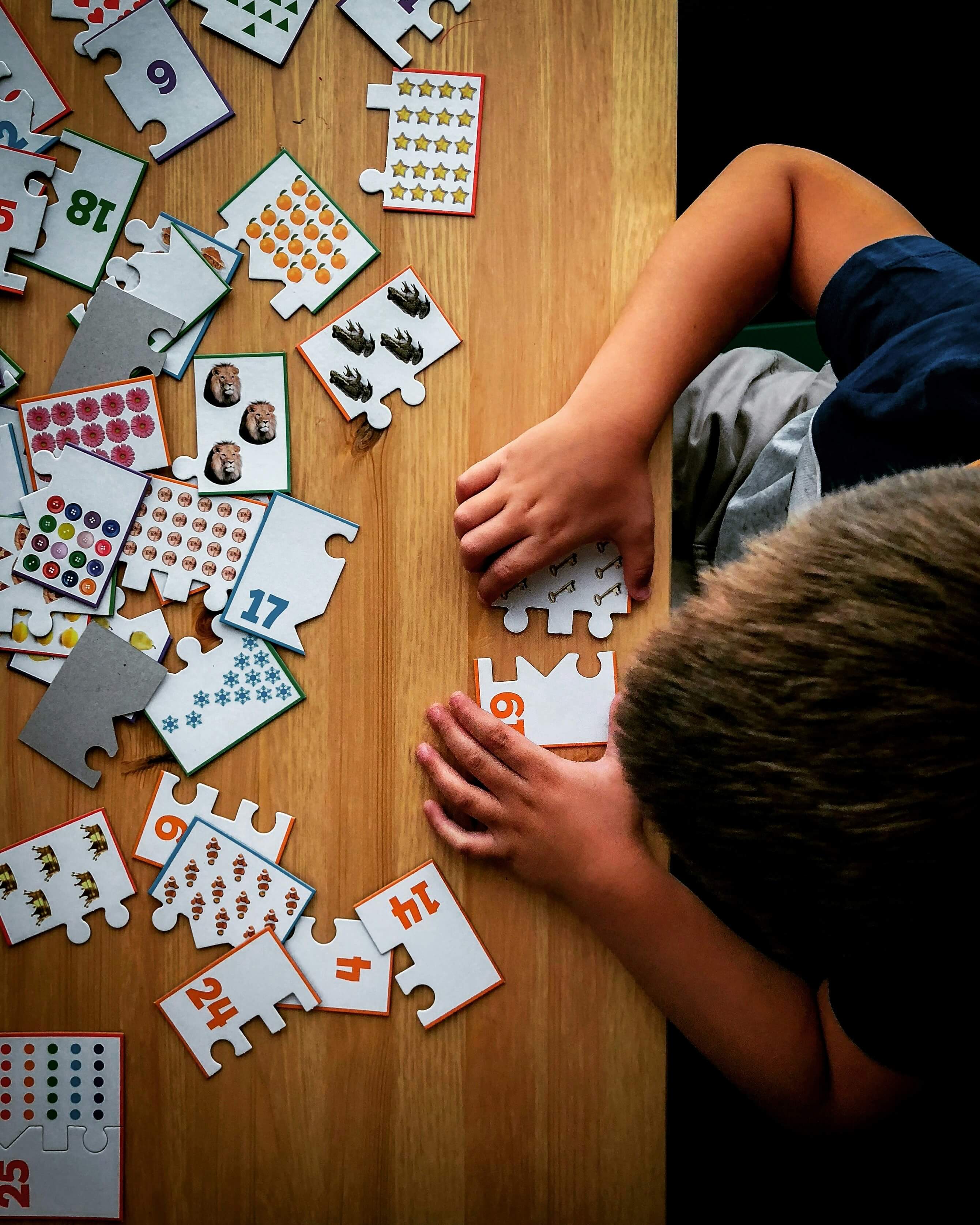 A child playing with a puzzle on a table