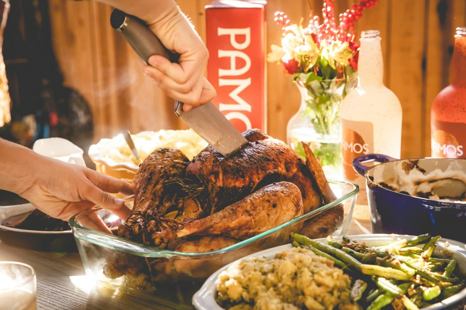 A person carving the turkey at Thanksgiving dinner, before the after-dinner games begin