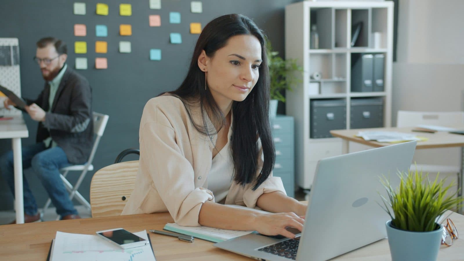 A woman working on a laptop in a modern office