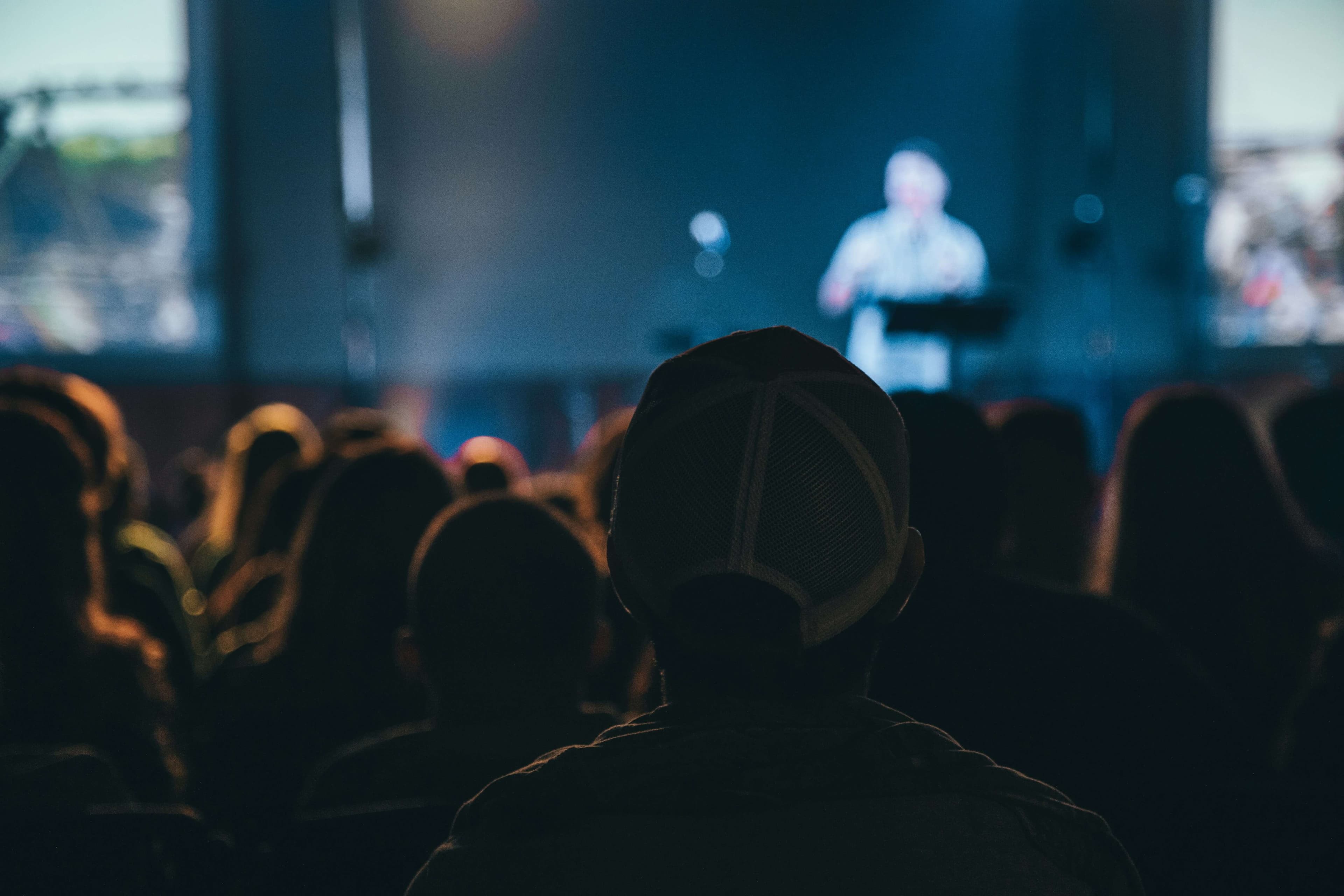 A crowd watching a stage at a conference